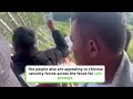 Footage shows Myanmar people arguing with Chinese border guards, scrambling from a smoke bomb