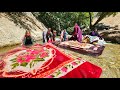 Washing Blankets In Raging Water By A Nomadic Family 