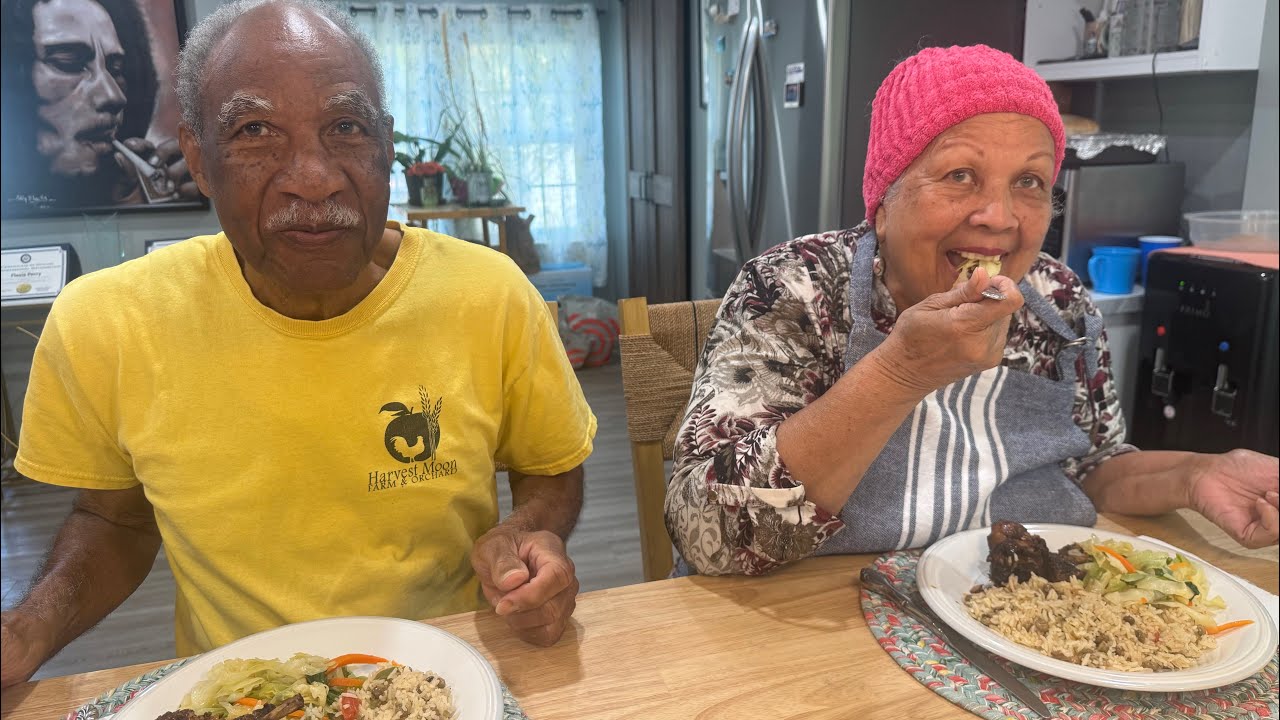 Brown Stew Chicken/ Rice & Peas and Vegetables. Home made style. Pops serving his wife.