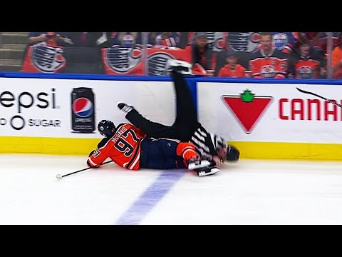 Linesman stretchered off after collision with McDavid