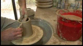 Throwing A Clay Bottle On The Potters Wheel Smoothing The Walls Of A Cylinder On The Pottery Wheel