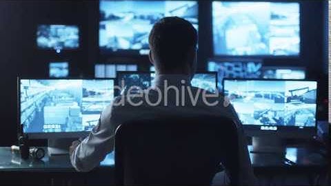 Security Officer Drinking Coffee while Working on Computer in Monitoring | VideoHive 14742424