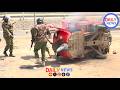 POLICE TRY SAVE COCA-COLA TUKTUK SET ON FIRE BY KITENGELA FUEL PROTESTERS