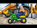 Tractor John Deere and Excavator JCB 3CX digging the sand