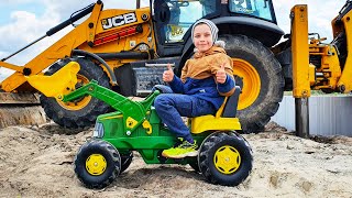 Tractor John Deere and Excavator JCB 3CX digging the sand