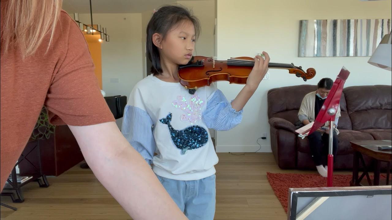 Her second violin lesson Leaning how to pluck the strings with left