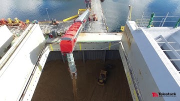 Telestack TB58 Radial Telescopic Conveyor loading woodchips to Panamax vessels