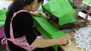 Furthertrade.com Worker Is Hot Pressing The Hood With Elastic Band