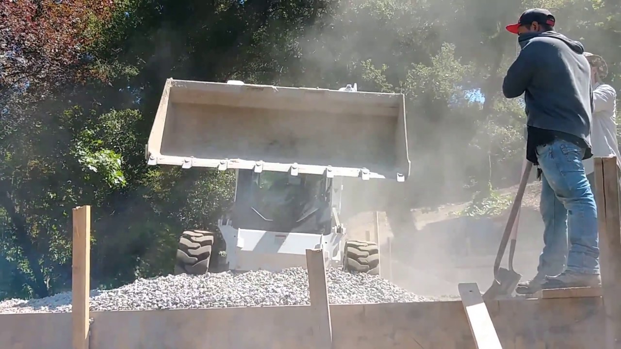 Veterans concrete,...drain rock install. progress ret. wall