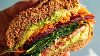 Nagis Salad Sandwich
Recipe ⬇️ or print: https://www.recipetineats.com/nagis-salad-sandwich/
Salad sandwiches can be so boring. This one isnt! I essentially treat it like a dressed salad stuffed in a roll with a little vinaigrette used to lightly pickle the carrot and dress the greens. Honestly, it is so much nicer than eating a mound of plain raw vegetables! - N x ❤️
Nagi’s Salad Sandwich
1 bread roll, wholemeal (on theme), soft
1 small carrot, peeled, grated using a box grater (3/4 cup grated per sandwich)
1/2 ripe avocado – smush in skin with fork with salt & pepper
1 lightly packed cup baby spinach leaves (or rocket, or sliced iceberg, kale, cos/romaine, or other perky leafy greens)
1/4 cup alfafa, tightly packed
1/2 tomato, sliced into rounds (3 – 4 slices)
3 – 4 beetroot slices (canned)
Few pinches salt and pepper
DRESSING – whisk in bowl:
1/4 tsp Dijon mustard (mainly for thickening, so it clings)
1 1/2 tsp apple cider vinegar, or red wine/white wine vinegar
1 tbsp extra virgin olive oil
1/2 small garlic clove, finely grated or use garlic crusher
1/8 tsp each salt and pepper
1. Toss carrot with 3/4 of the dressing in a bowl (leave rest of dressing in separate bowl). Just prior to assembling, toss baby spinach in rest of dressing (I use the bowl I made the dressing in and “wipe” the walls/base clean using the baby spinach).
2. Split roll, smear avocado on lid and base. Top base in this order: tomato, sprinkle salt and pepper, baby spinach, beetroot, grated carrot, alfalfa, lid. EAT!
#recipetineats #saladsandwich #veggiesandwich Nagis Salad Sandwich