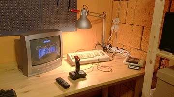 C64 with CRT loading a 1987 game from tape