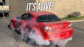 Pulling the crashed RX-8 until it starts.