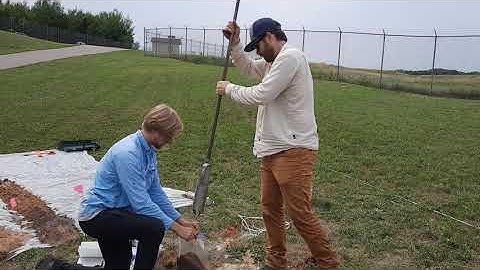 Chris Zahasky and Elliot Draxler use an auger to collect soil samples