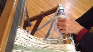 Threading the reed on the loom