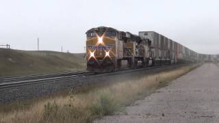 EBD Union Pacific #7362 Stack train passes WBD Herzog train @ Borie, WY 9/15/13