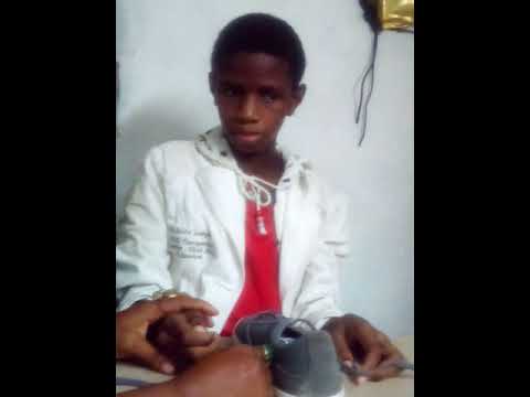 13 year old Autistic child tying his shoe lace