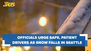 Officials urge drivers to be safe, patient as snow falls in Seattle