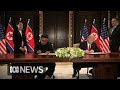 Donald Trump and Kim Jong-un sign document after summit