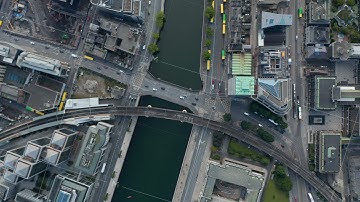 Aerial birds eye overhead top down view of traffic on bridge across Liffey river. Railway bridge