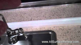 Plain white formica countertops.  Refinished in a stone-like finish.