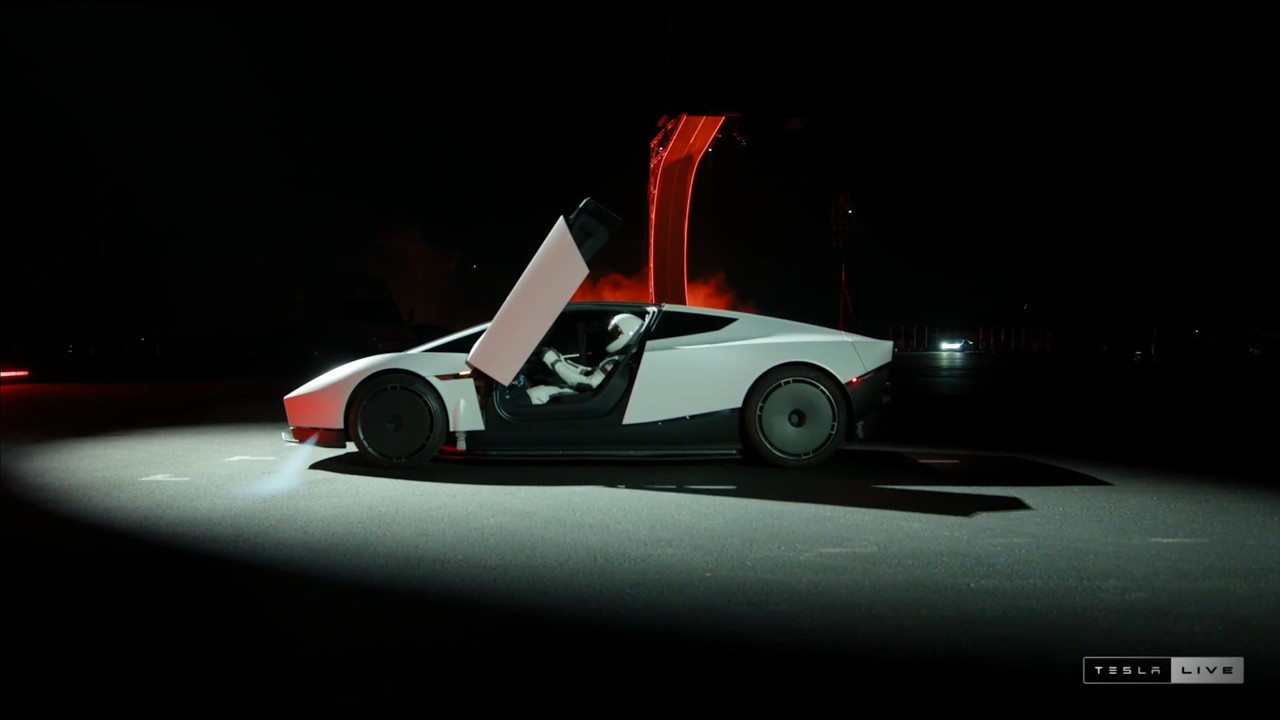 White 2026 Tesla Roadster with butterfly door open at the McGregor, Texas unveiling event