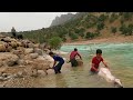Washing sheep in the river by nomadic men