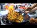 Chinese street food fried noodles with egg fried rice fried broiler egg and vegetable pie