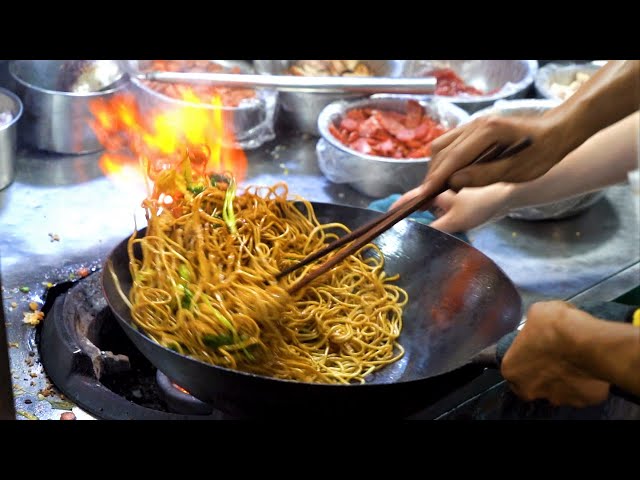 Chinese Street Food -Fried noodles with egg fried rice, fried broiler, egg and vegetable pie class=