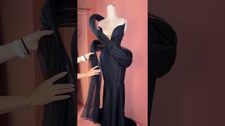 Share with a friend or tag a friend who would own the spotlight in this avant-garde black gown! To