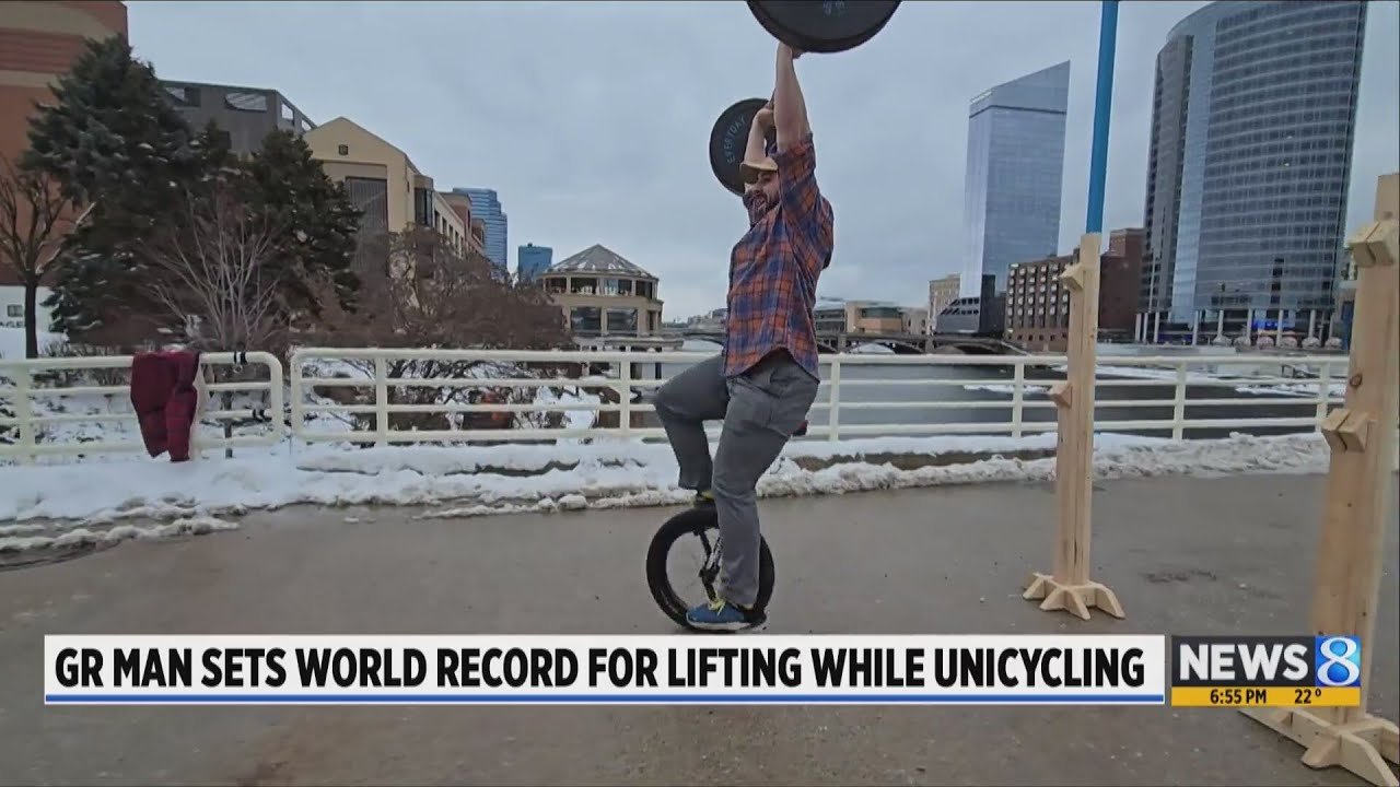 World record set as GR man lifts 206 pounds while riding unicycle - YouTube