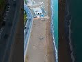 Vertical video. Mersin, Turkey. Aerial drone flight over sandy beach and wave surge towards sea i...