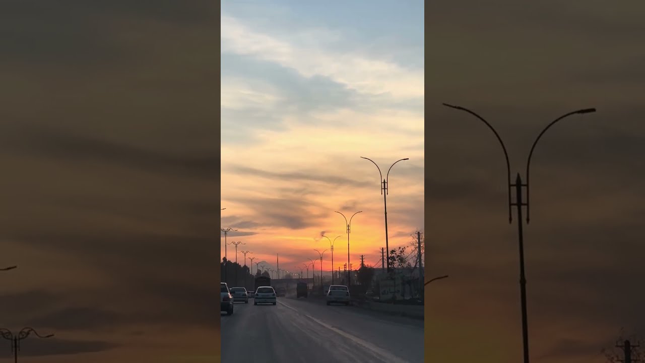Driving under a red sky at sunset
