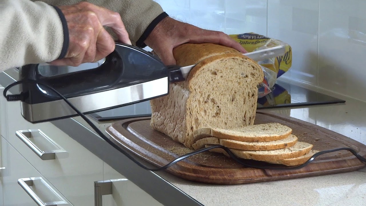 Slicing a bread loaf with an electric knife 