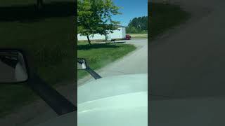 Tractor trailer backs off street (cab view)
