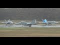 Eight RAAF F/A-18A  Hornets depart soggy Hobart