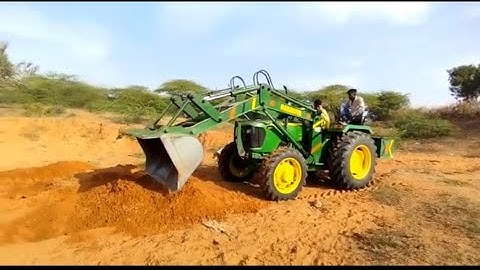Clay bucket loader mounted on tractor