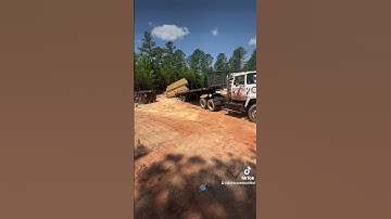 Unloading roof trusses with rolling deck trailer