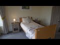 We hope you enjoy our virtual tour for Glenfairn House Care Home in Ayr. To find out more about the care we provide or to enquire today, please speak to our Enquiry Support Team on 0800 917 0478.

Transcript:
Welcome to Glenfairn House   
Sanctuary Care’s stunning residential and nursing home in Ayr.  
With top floor views of the Isle of Arran, our home boasts beautiful period features and fantastic facilities to match.  Our highly skilled staff provide residential, nursing, dementia and pre-bookable respite care. 
Our 65 bedrooms are all beautifully decorated and have en-suite toilet and washing facilities. Many of our upstairs bedrooms overlook the Isle of Arran and some of our ground floor rooms have access directly out to our beautiful gardens. 
At the heart of the home are our stunning lounge and dining areas where our residents come together to relax, socialise and enjoy home-cooked meals including delicious country fayre. 
Our residents also love taking afternoon tea – with finger sandwiches and sweet treats; they really are a special occasion. 
Our dedicated team at Glenfairn House pride themselves on the range of activities we offer, enriching the lives of our residents every single day - from pamper sessions with hand massages and pedicures to games afternoons from the comfort of our lounge or out in our glorious grounds in the warmer weather – there is always something to do!
We are also very lucky to have some talented musicians within our team, who perform for our residents whenever they can. 
The gardens at Glenfairn House really are special – and are lovingly tended to by our longstanding gardeners. With beautiful planting and wheelchair-friendly pathways, our residents can enjoy our gardens all year round – with picture-perfect views from many of our lounge areas for when the weather is a bit cooler.  

Thank you for taking our virtual tour, for more information or to enquire today call our Enquiry Support Team. 

We look forward to welcoming you to Glenfairn House soon.