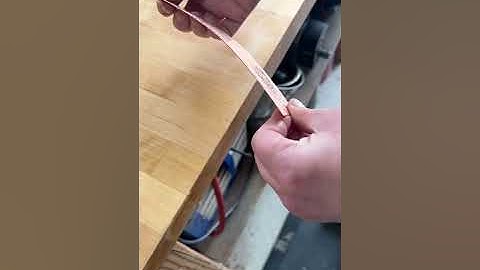 Straightening curved metal after rolling textures through a mill.