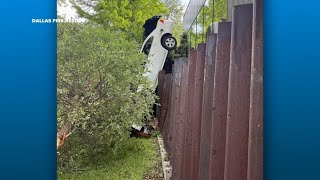 Dallas firefighters rescue driver after car crashes between fence, tree, officials say
