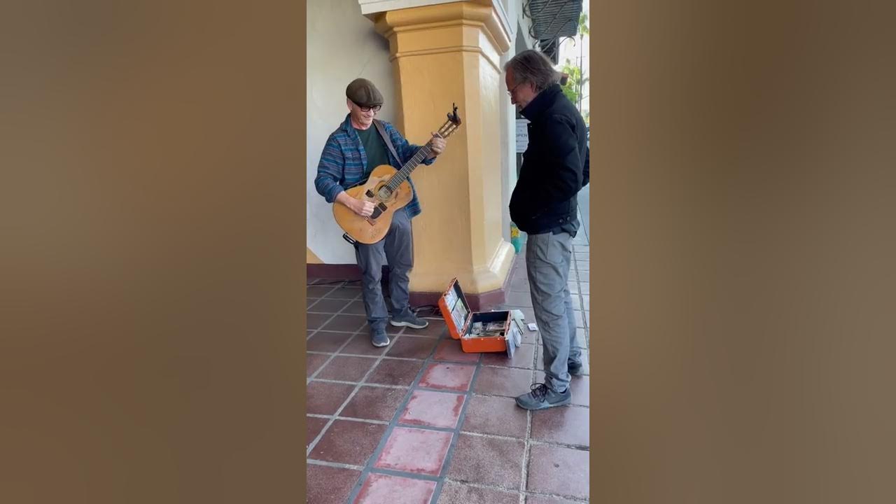 I’m busking when Jackson Browne ambles up to swap tunes and stories & gives me his cool thumbpick.