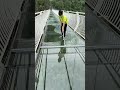 Use a big mop tool to clean the transparent glass skywalk 