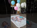 Triplets playing with balloons