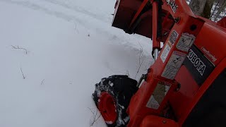 kubota BX 2200 in snow driving out to move custom log mover.