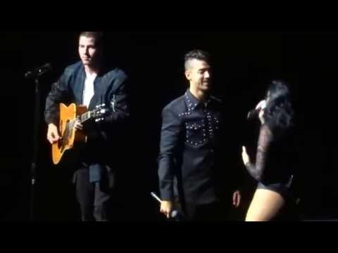 Joe Jonas and Demi Lovato singing "This is Me" with Nick on guitar