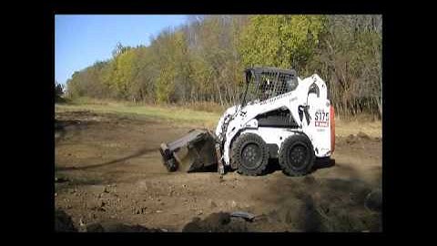 Bobcat with pulverizer on interface plate loading CEB hopper.wmv