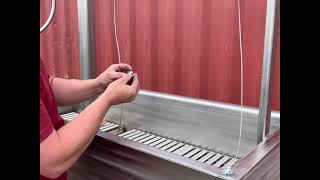 How to install a round wheel, ratchet bar, and cable on a stainless grill