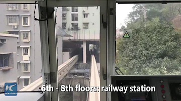 Watch: This train passes through residential building in China!