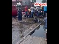 Lagosians scooping groundnut oil from a fallen tanker along the Iyana-Iba - Igando road