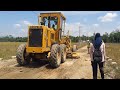 Spreading out aggregate and compaction with Cat 120G Motor Grader and Cat CS 531C Vibrator Roller